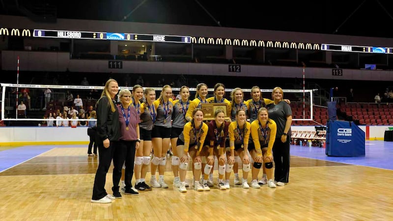The Hillsboro Trojans pose with the Class 2A State Championship Trophy. The Hillsboro Trojans...